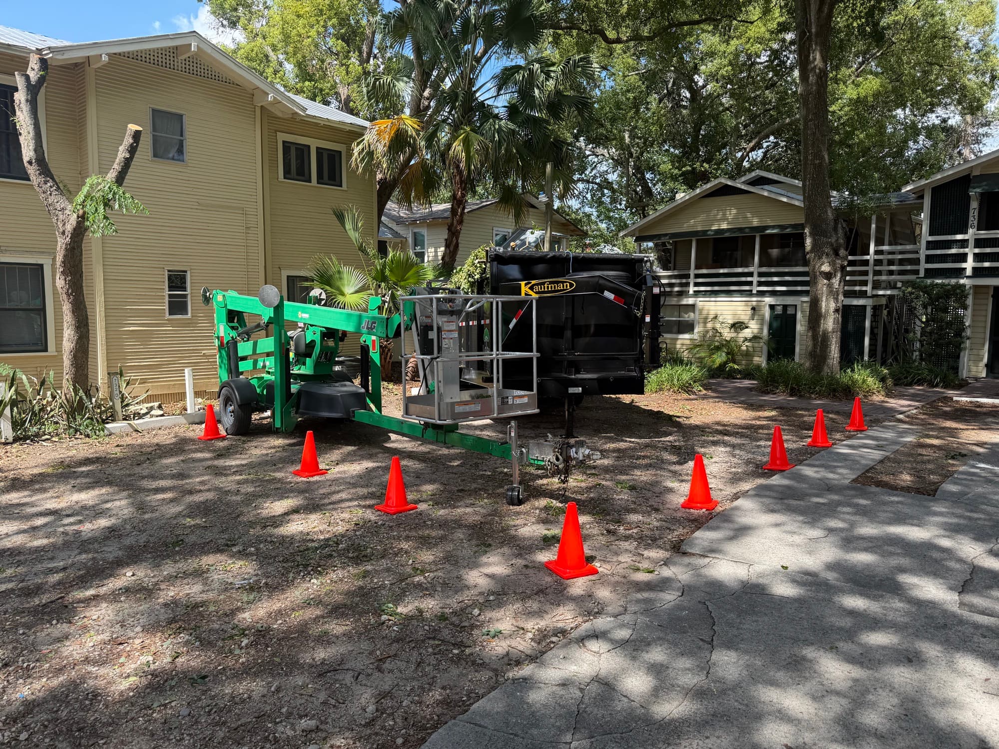 Aerial lift positioned for ISA Certified Arborist tree work at a Central Florida site